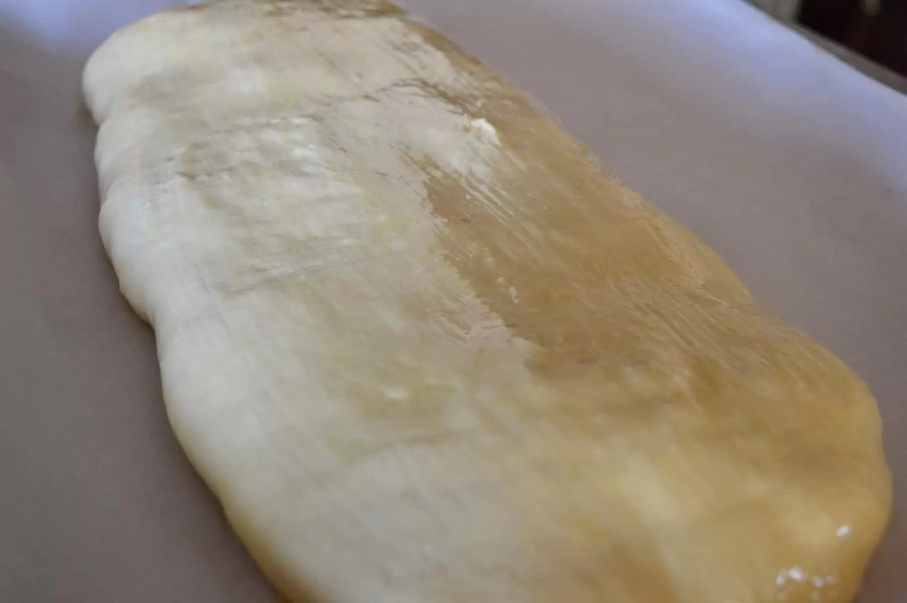 puff pastry wrapped fish on a baking sheet 