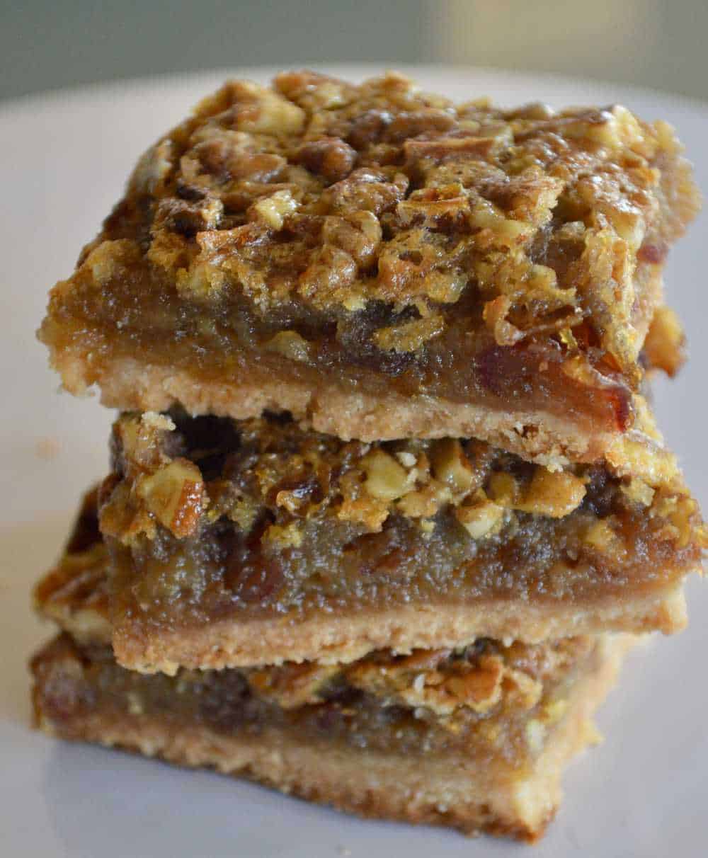 Pecan Pie Bars piled high on a white plate