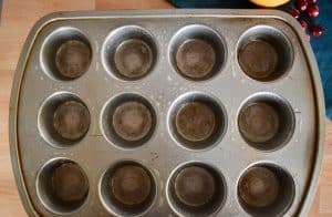 spray muffin tin with cooking spray.