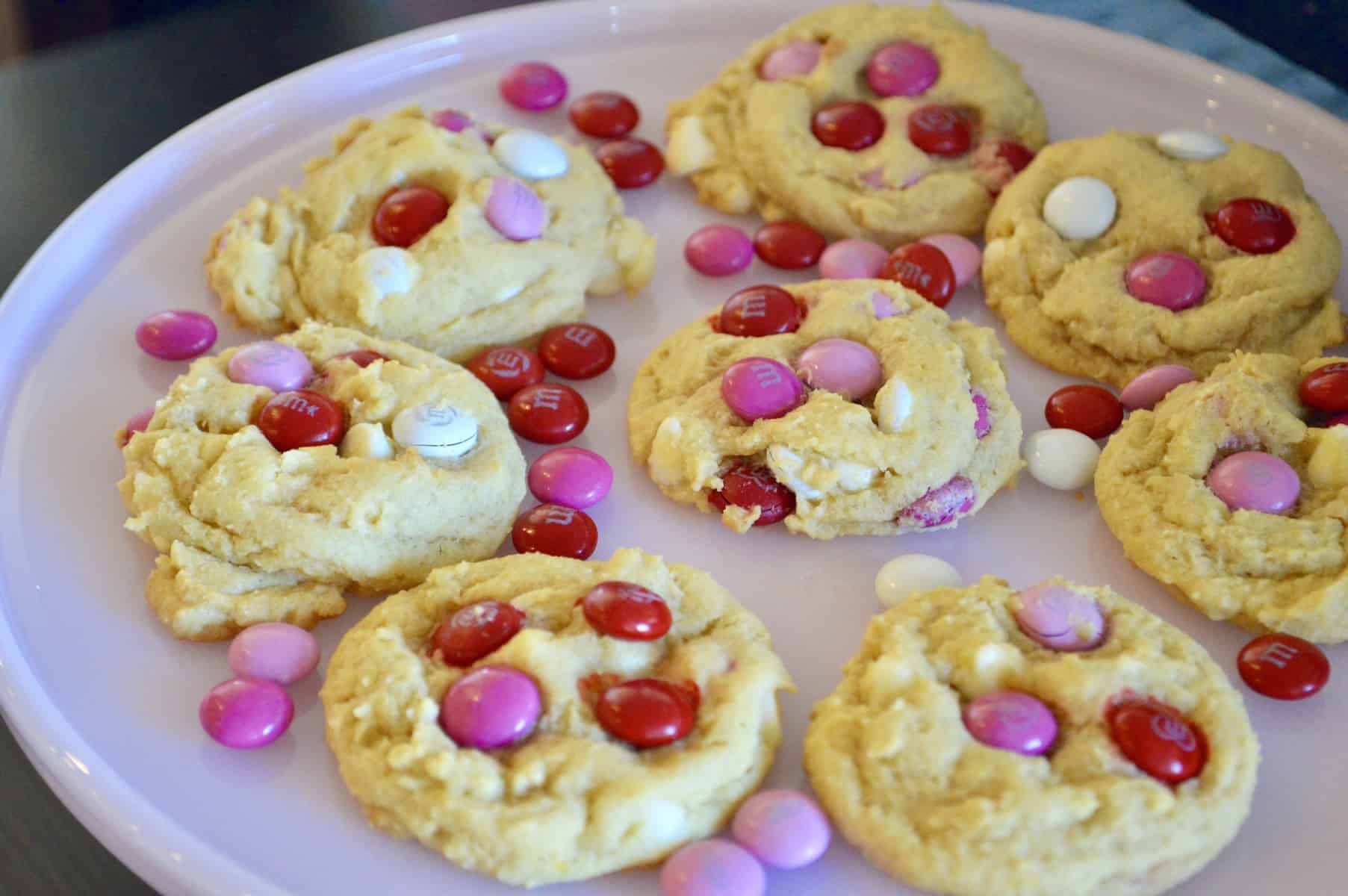 Valentine's Day M&M cookies on a pink cake stand 
