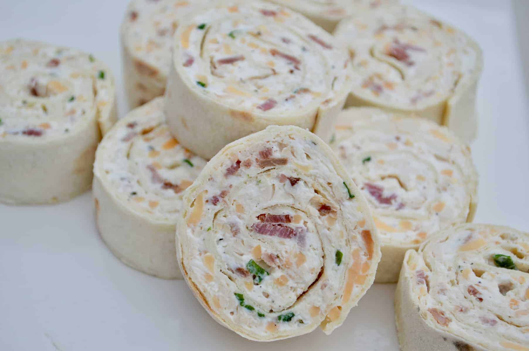 chicken bacon ranch pinwheels on a white platter 
