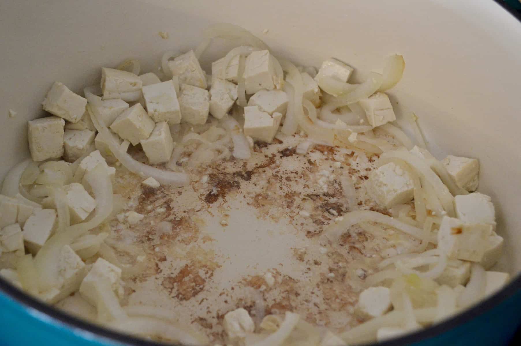onions and tofu in a pot for curry 