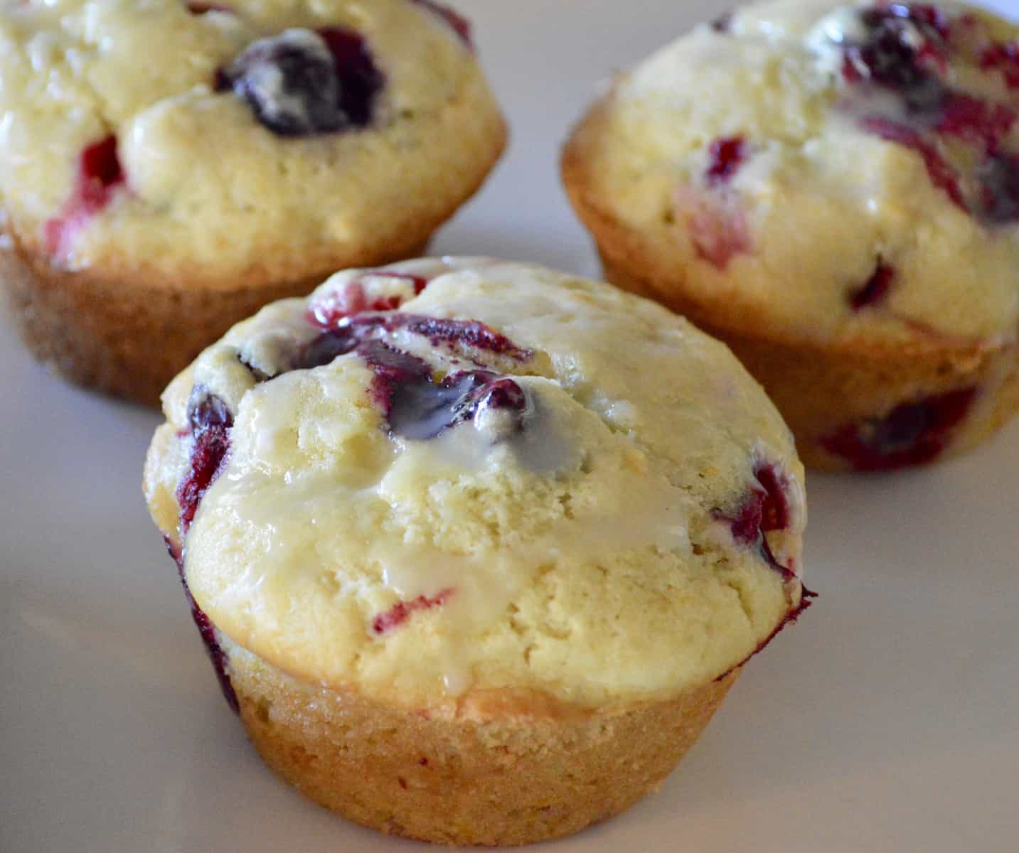 Cranberry orange muffins on a white plate 