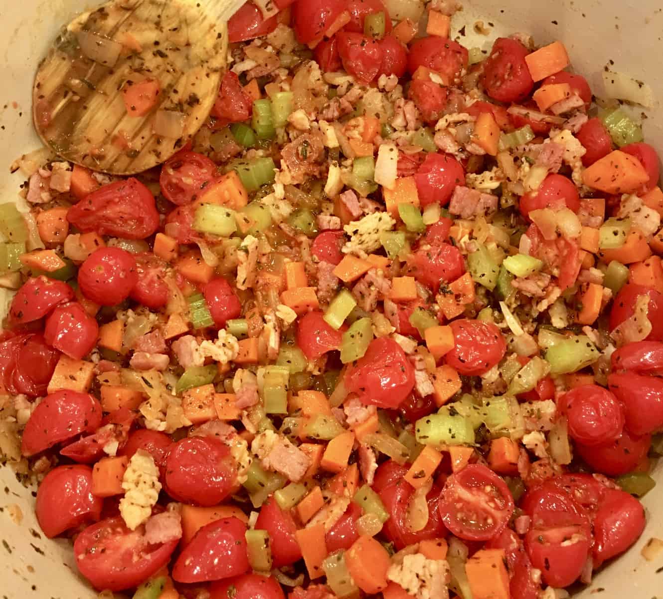 tomatoes, bacon, and mirepoix cooking for pasta e Fagioli Soup 