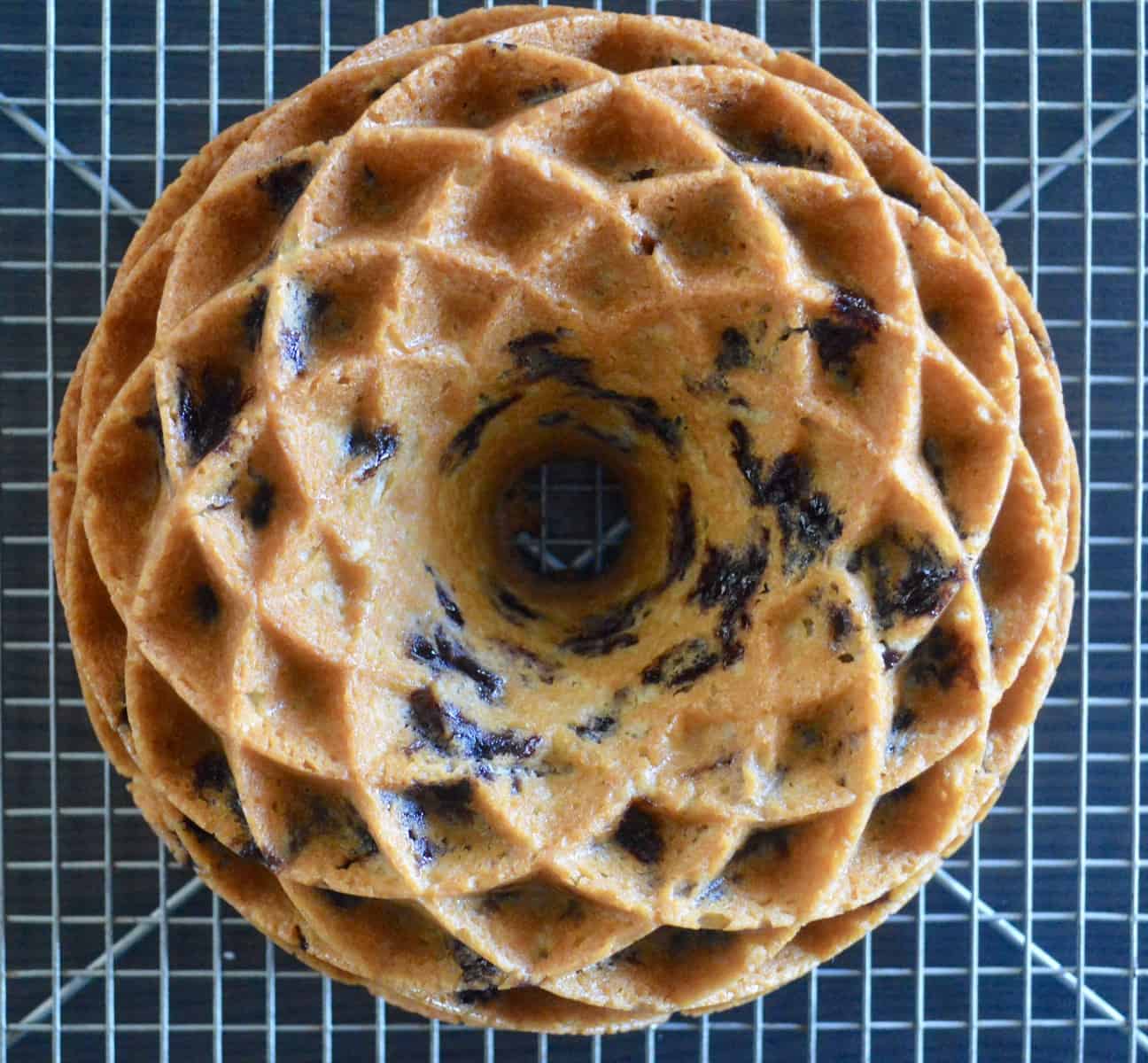 blueberry lemon bundt cake baked in a jubilee cake pan cooling on a wire rack