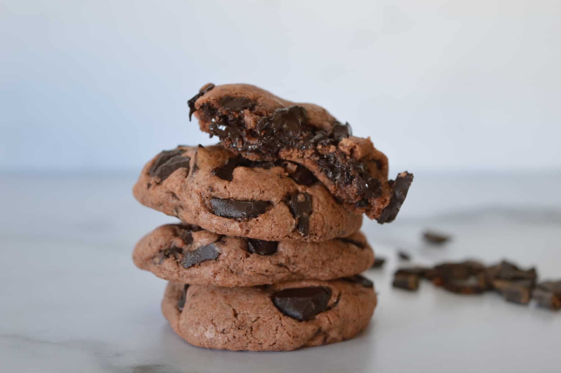 double chocolate pudding cookies stacked on top of each other on a counter 