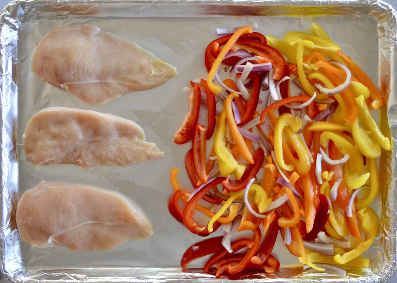 cook the chicken and bell peppers on a foil-lined baking sheet