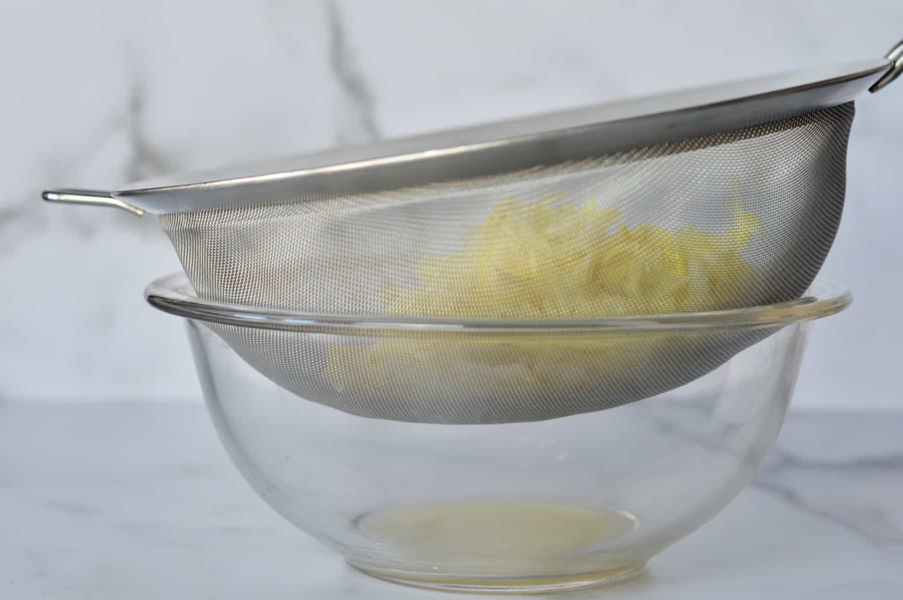 press moisture out of summer squash using a fine mesh sieve