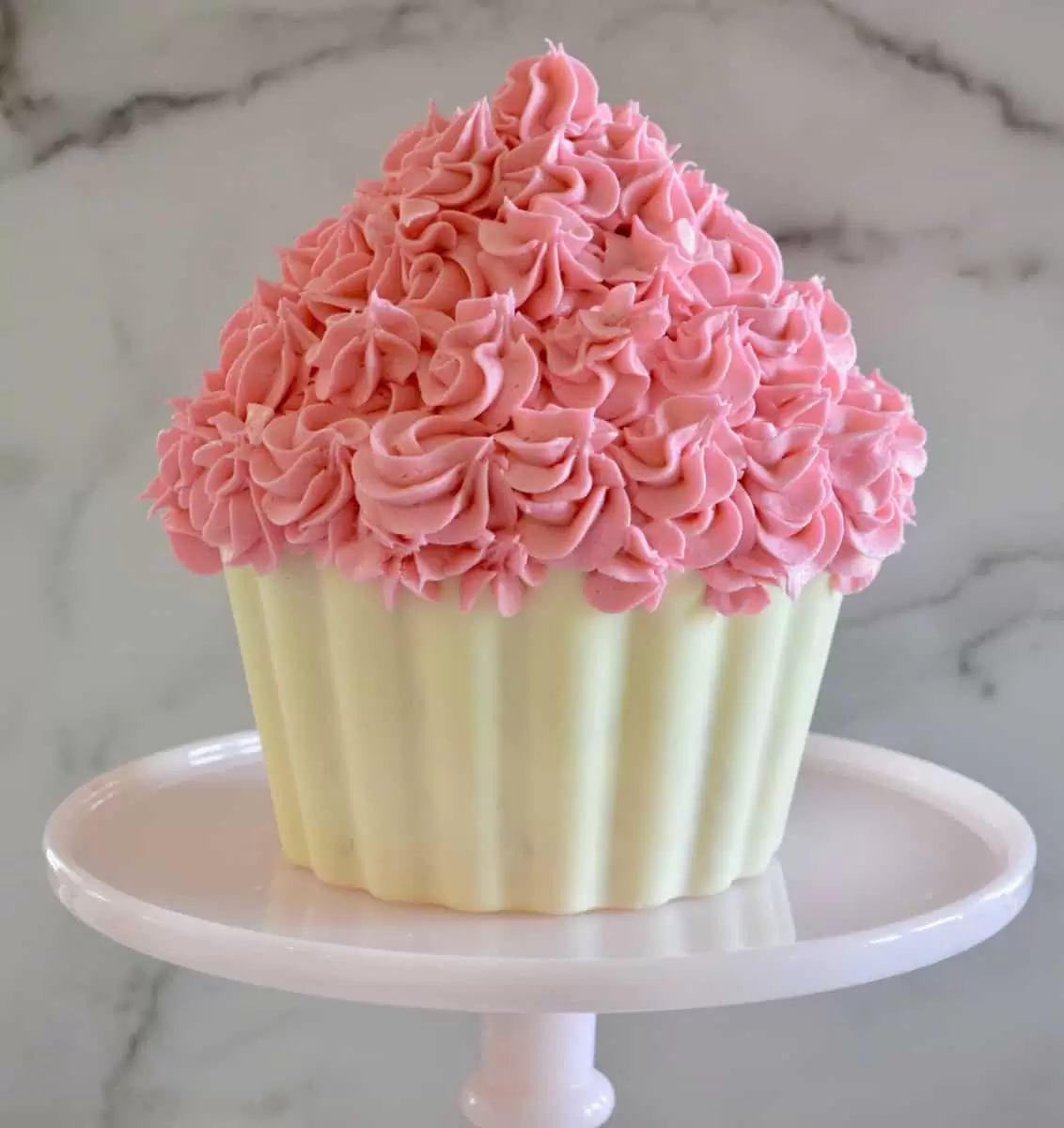 cupcake cake on a pink pedestal 