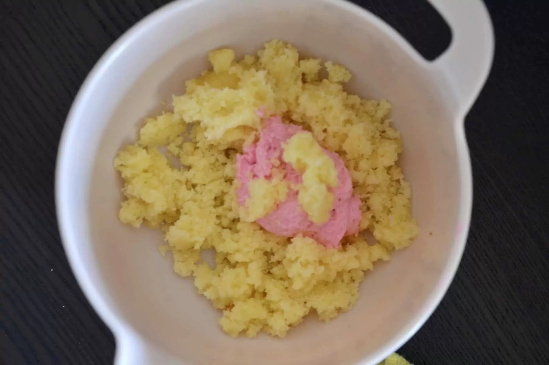 cake pieces in a bowl with pink frosting