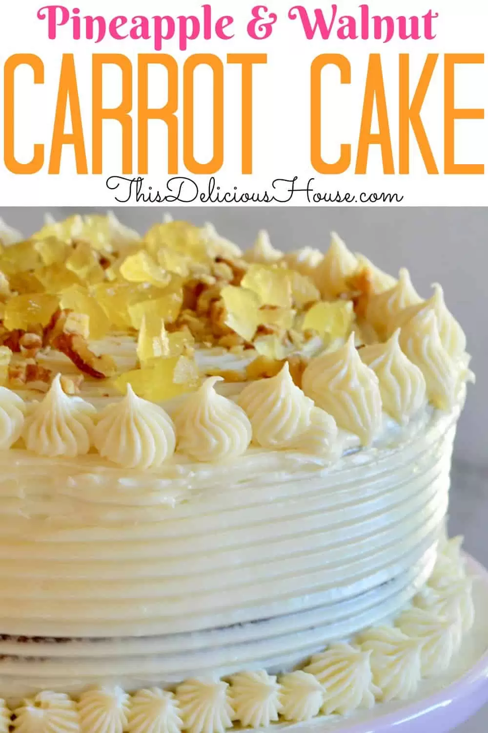 carrot pineapple cake with candied pineapple and walnut topping on a pink pedestal 