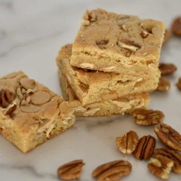 Caramel Pecan Bars stacked on a countertop