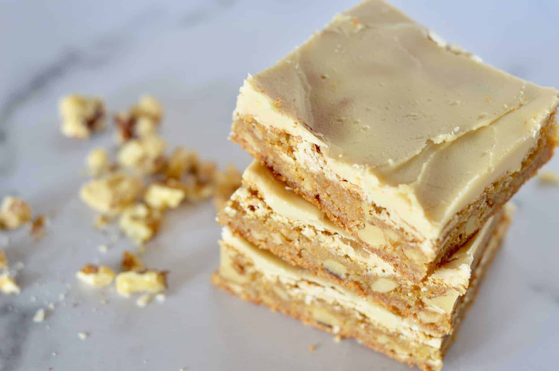 frosted butterscotch blondies stacked on each other