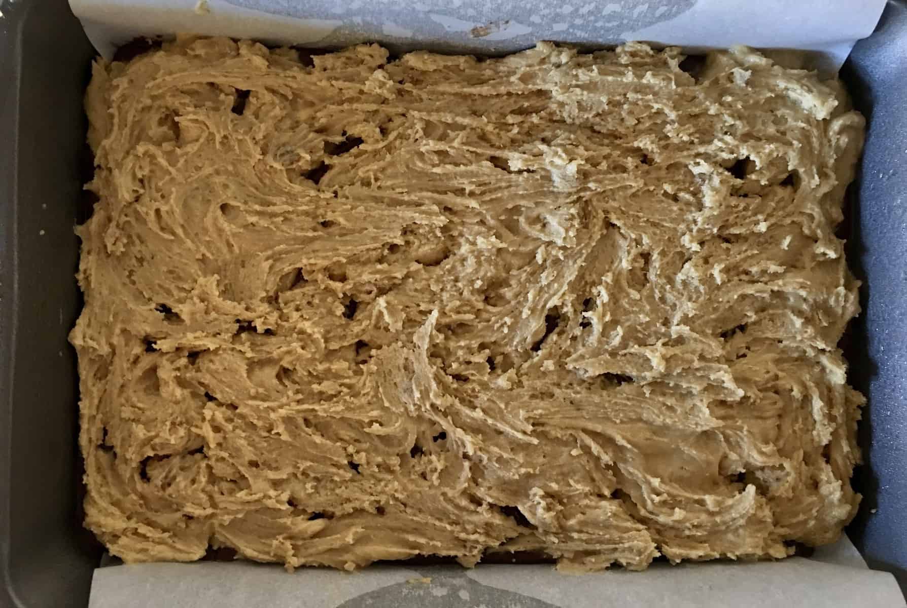 Blondie layer spread over the brownie layer in pan. 