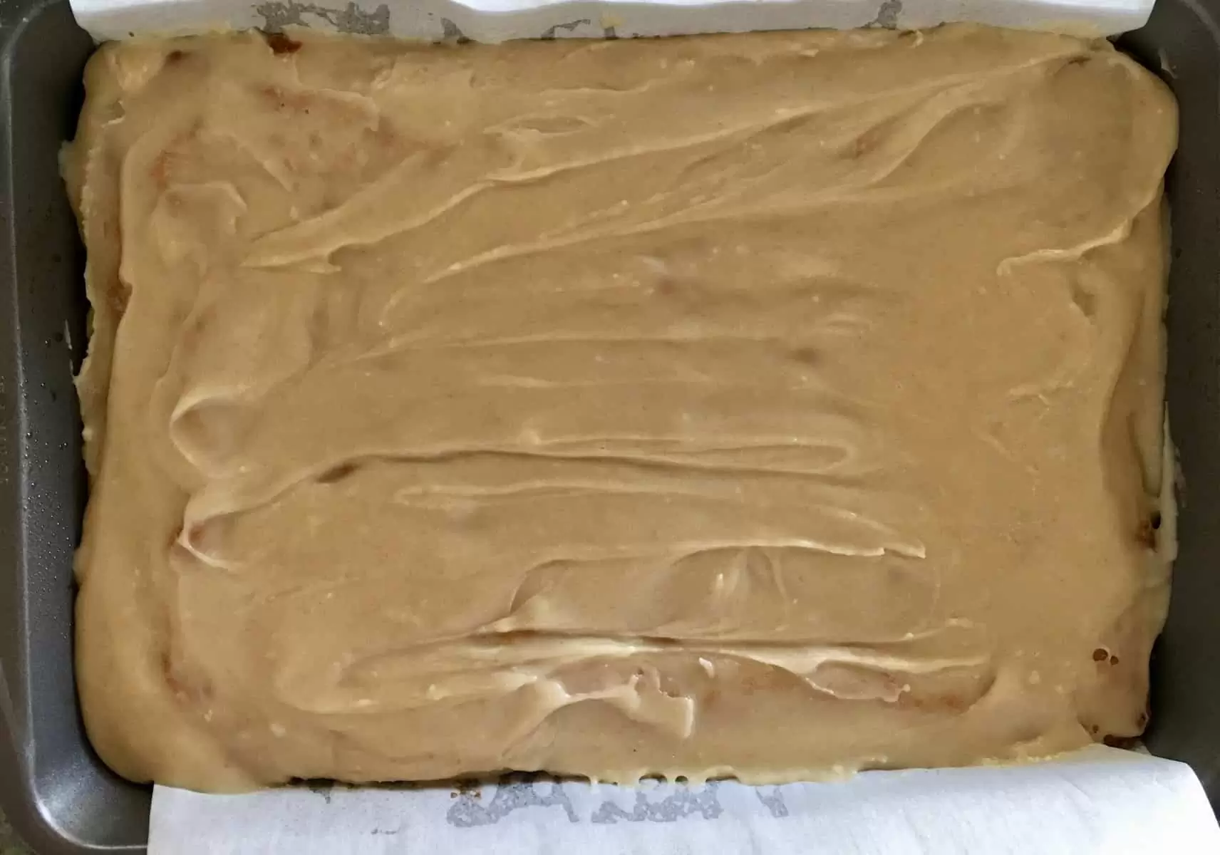 Icing layer on the cooled brownie blondie bars.