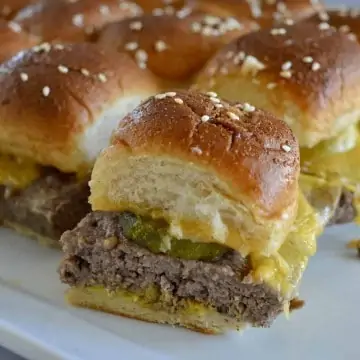 Easy baked cheeseburger sliders on a white plate.