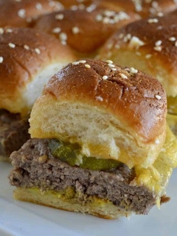 Easy baked cheeseburger sliders on a white plate.