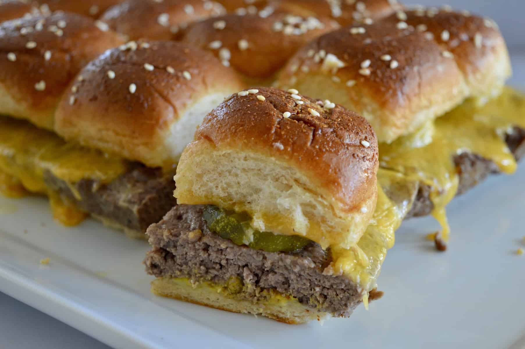 Easy baked cheeseburger sliders on a white plate.