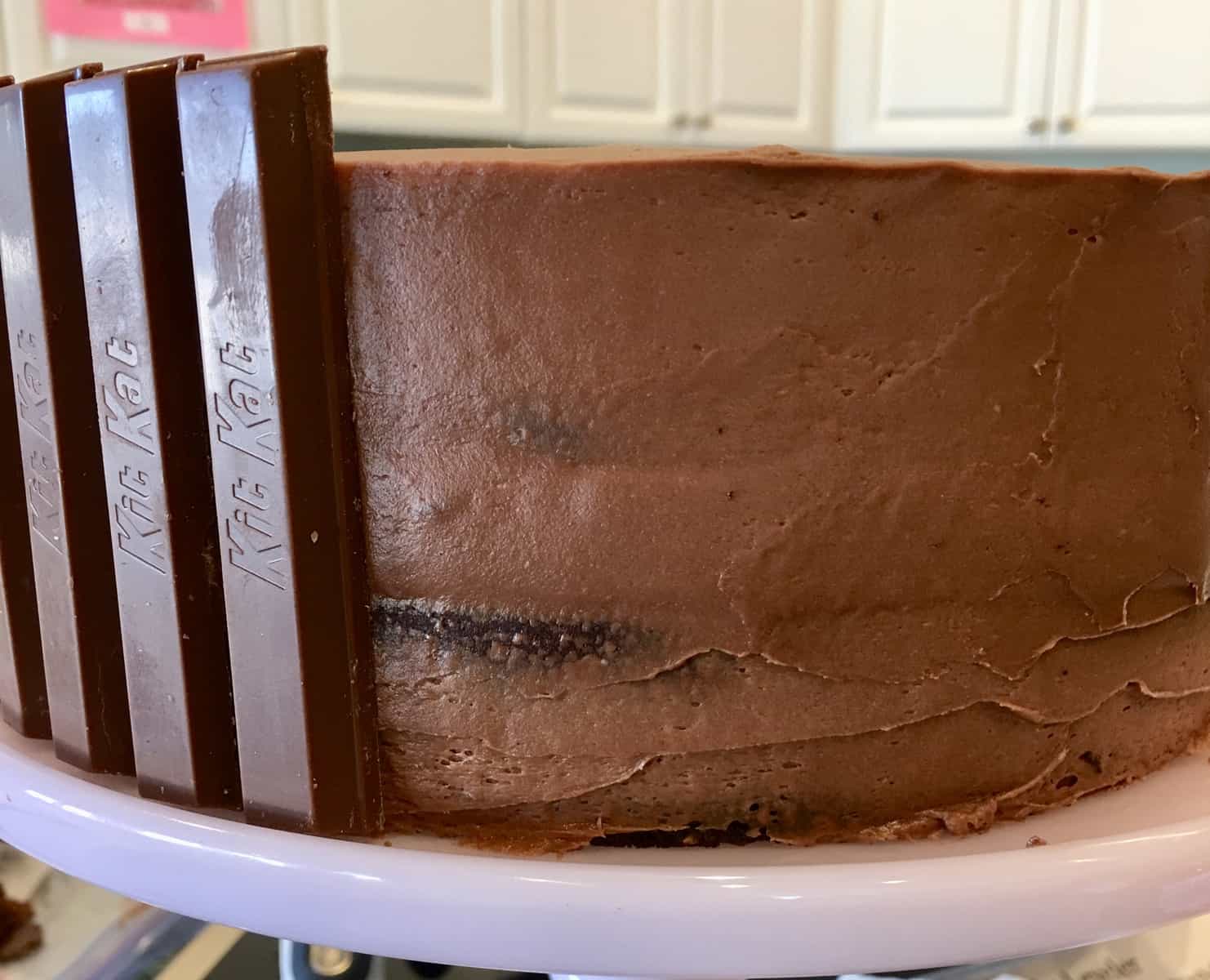 chocolate cake with Kit Kat bars stuck along of the side