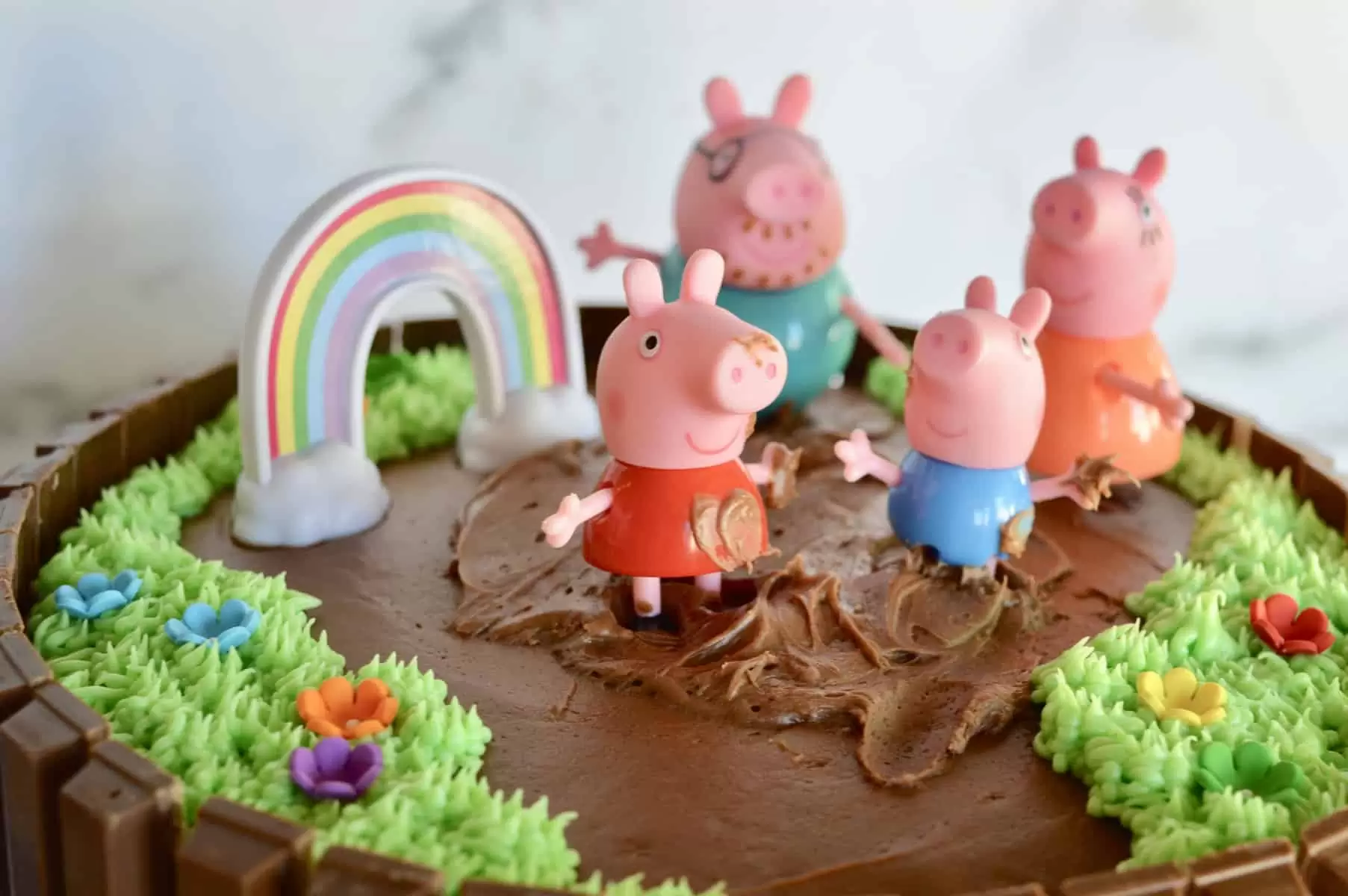 use chocolate frosting to add mud to peppa and George's hands 