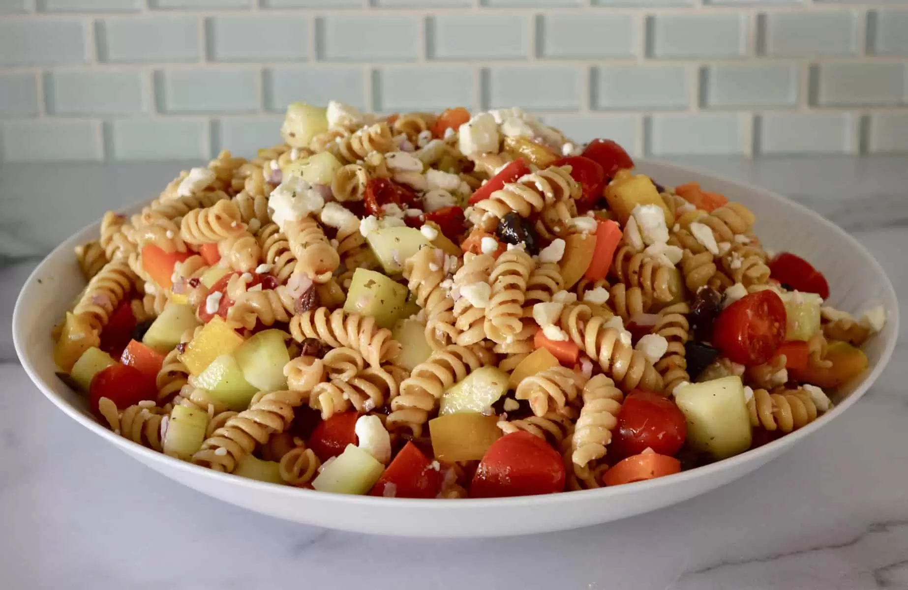 Whole Wheat Greek Pasta Salad in a white bowl. 