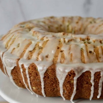 Pineapple Zucchini Cake on a white pedestal.