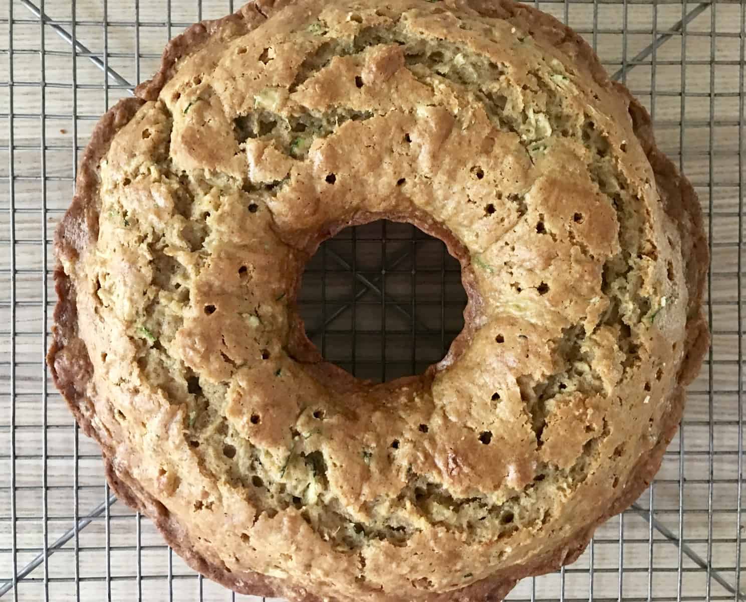 holes poked into top of cooled pineapple zucchini Bundt Cake. 