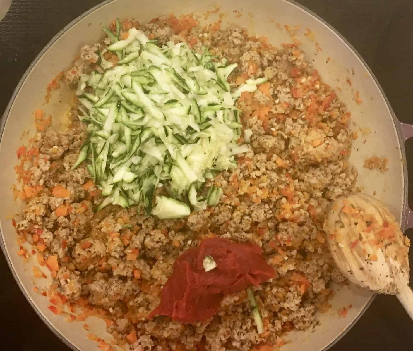 Shredded zucchini and tomato paste in the meat sauce. 