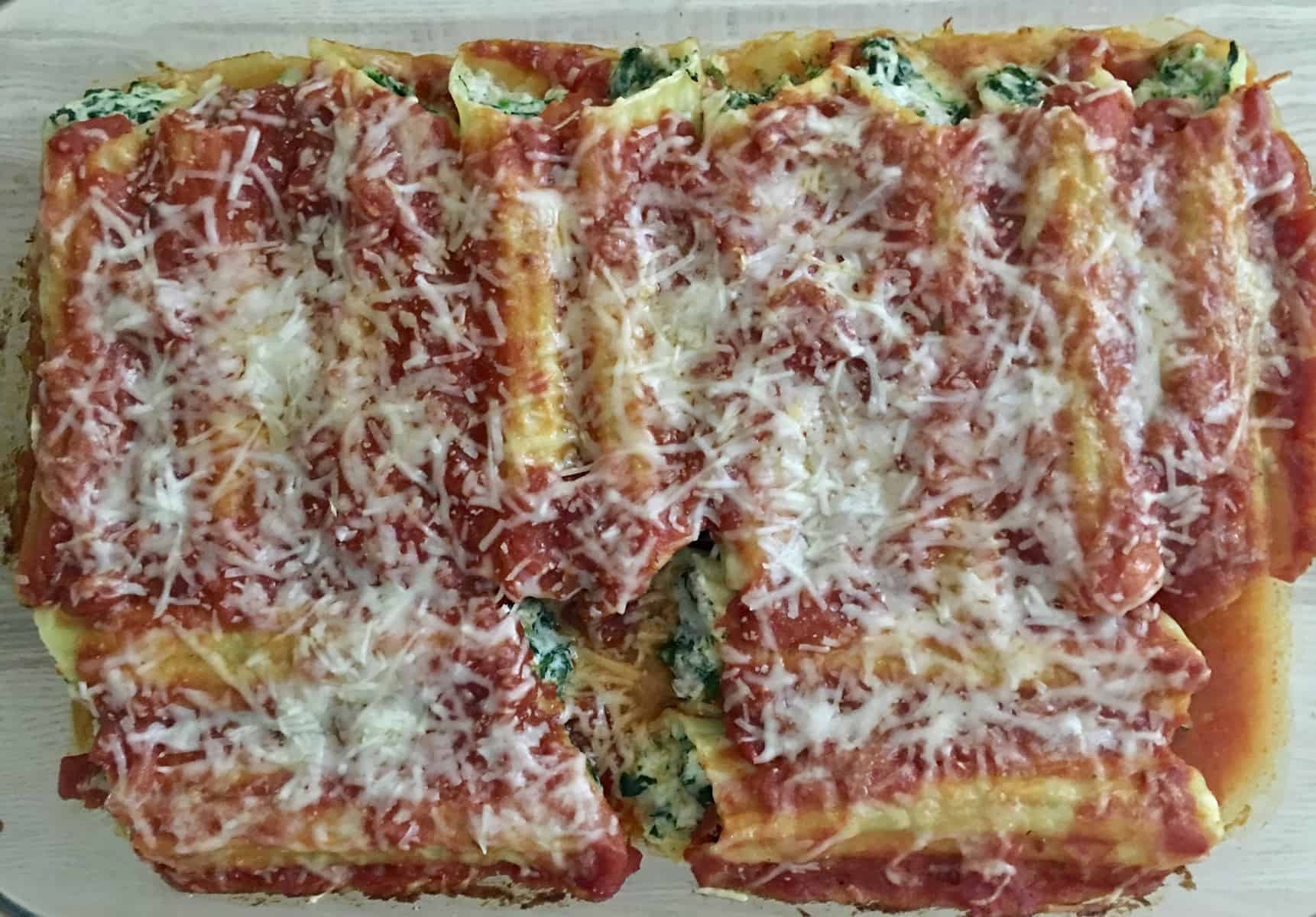 turkey and spinach manicotti in a glass baking dish . 
