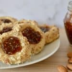 Italian Fig and almond cookies on a plate with fig jam in the background.