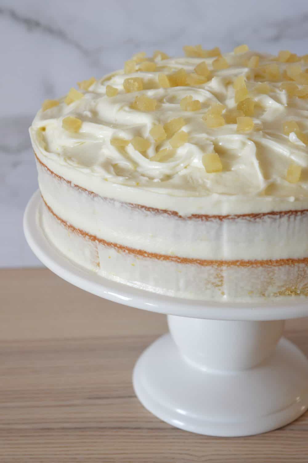 limoncello ricotta cake on a white pedestal. 