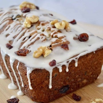 Cranberry Walnut Banana Bread on a wooden cutting board.