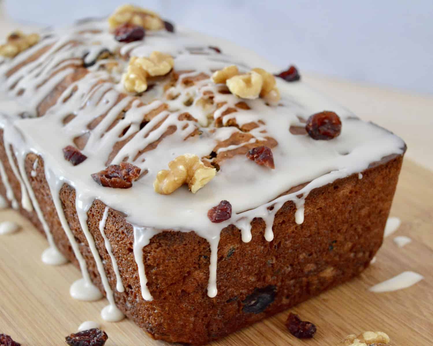 Cranberry Walnut Banana Bread on a wooden cutting board.