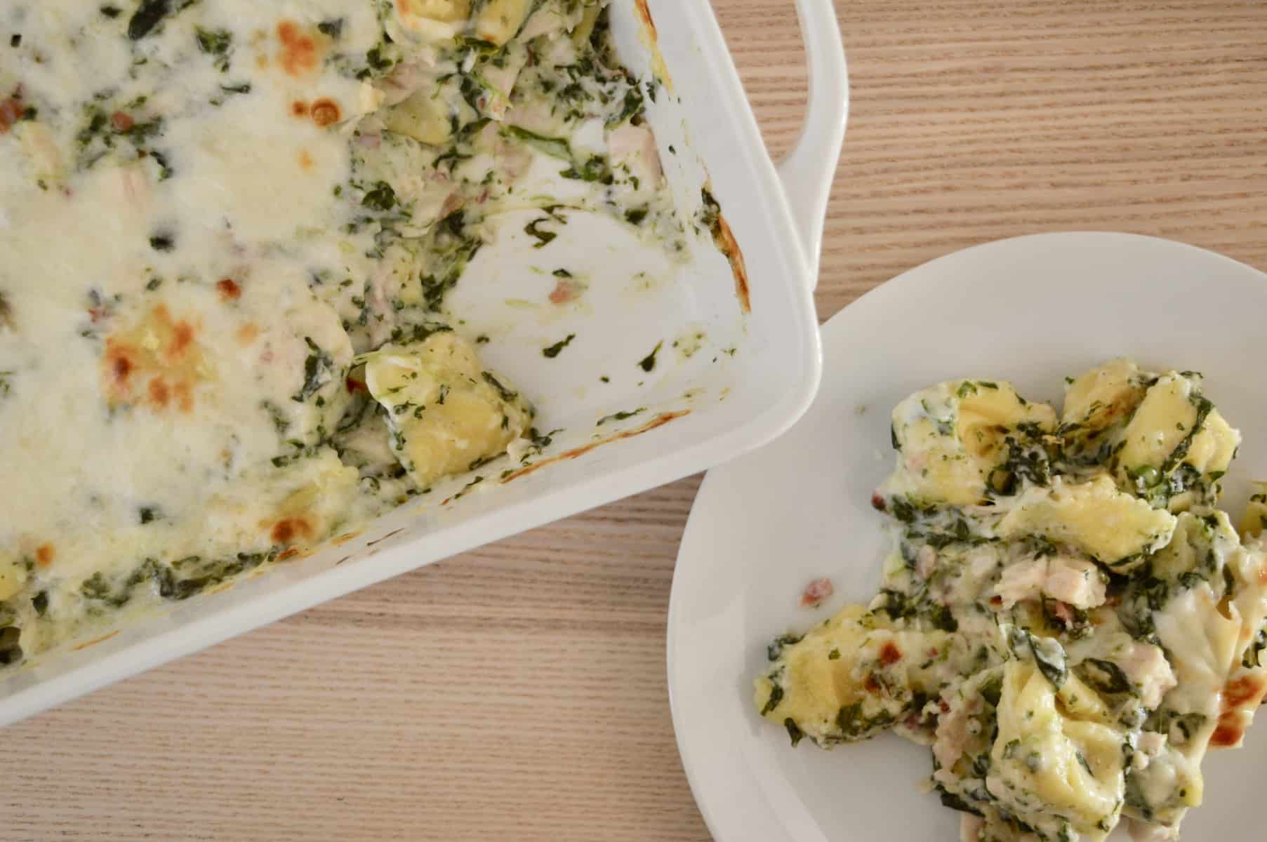 baked tortellini casserole with a white plate. 