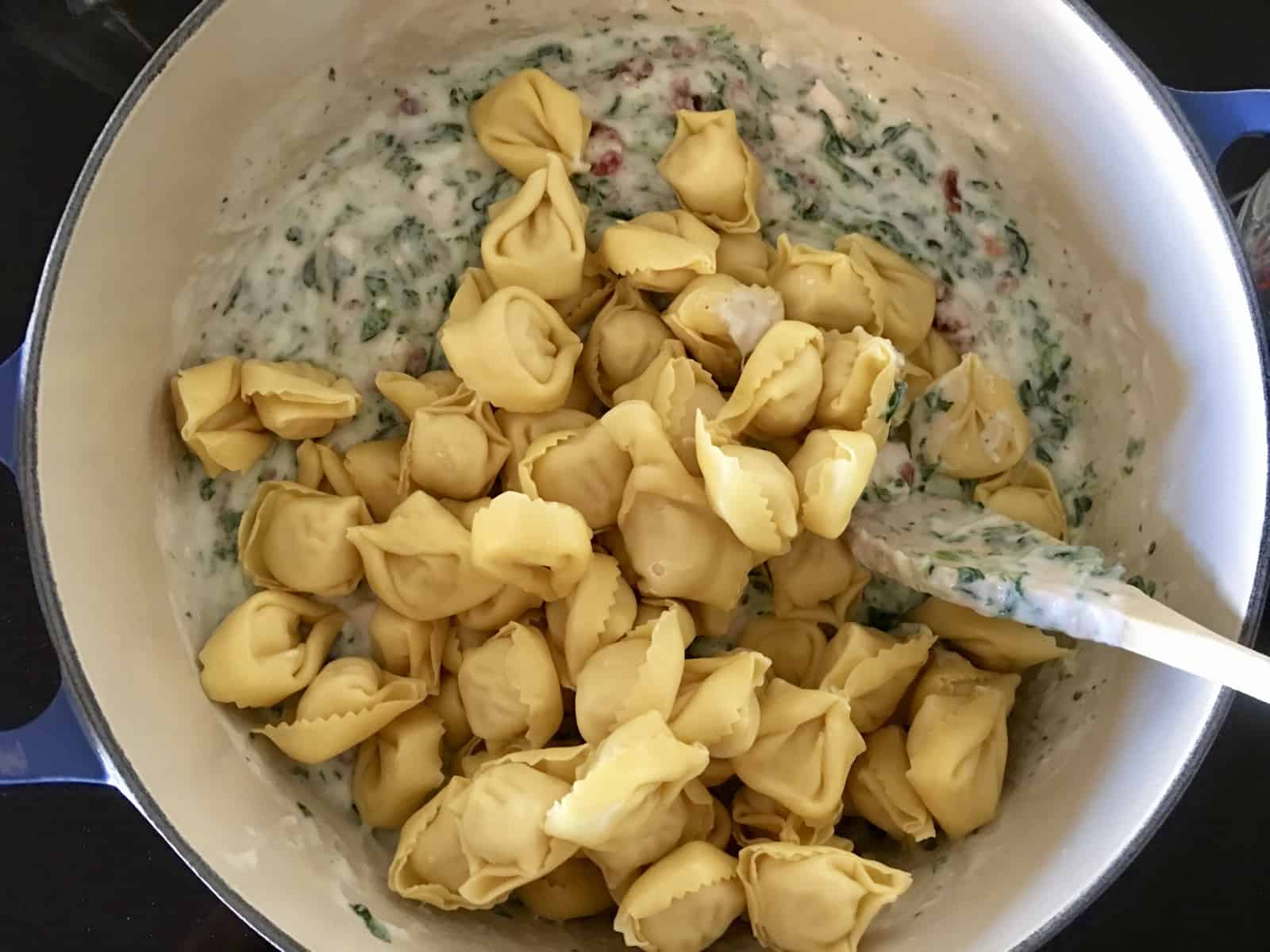 tortellini on top of spinach alfredo mixture. 