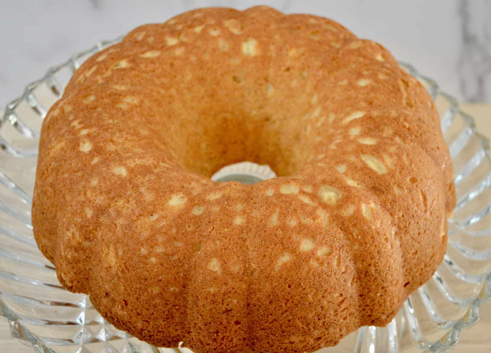 unglazed ciambella on a glass pedestal. 