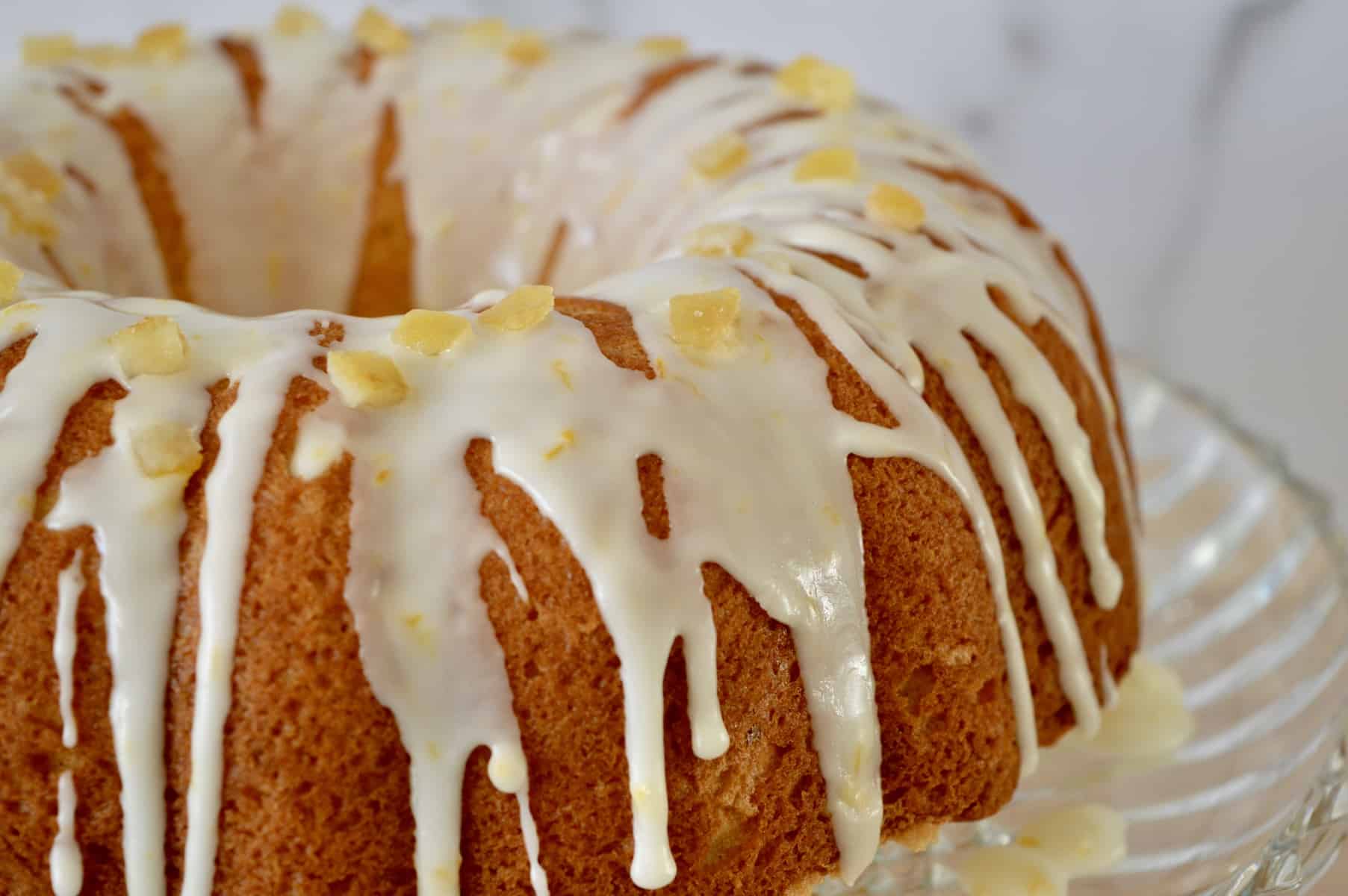 Orange Mascarpone Ciambellla on a glass cake pedestal. 