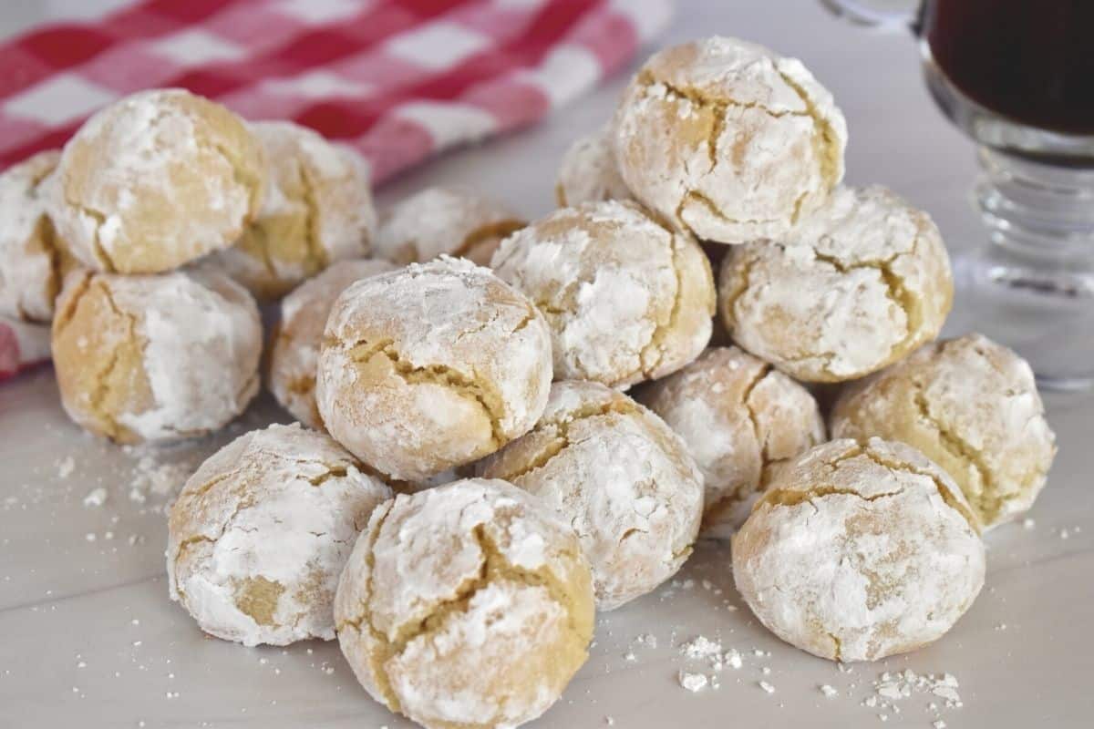 Soft Amaretti cookie recipe piled high on a countertop. 