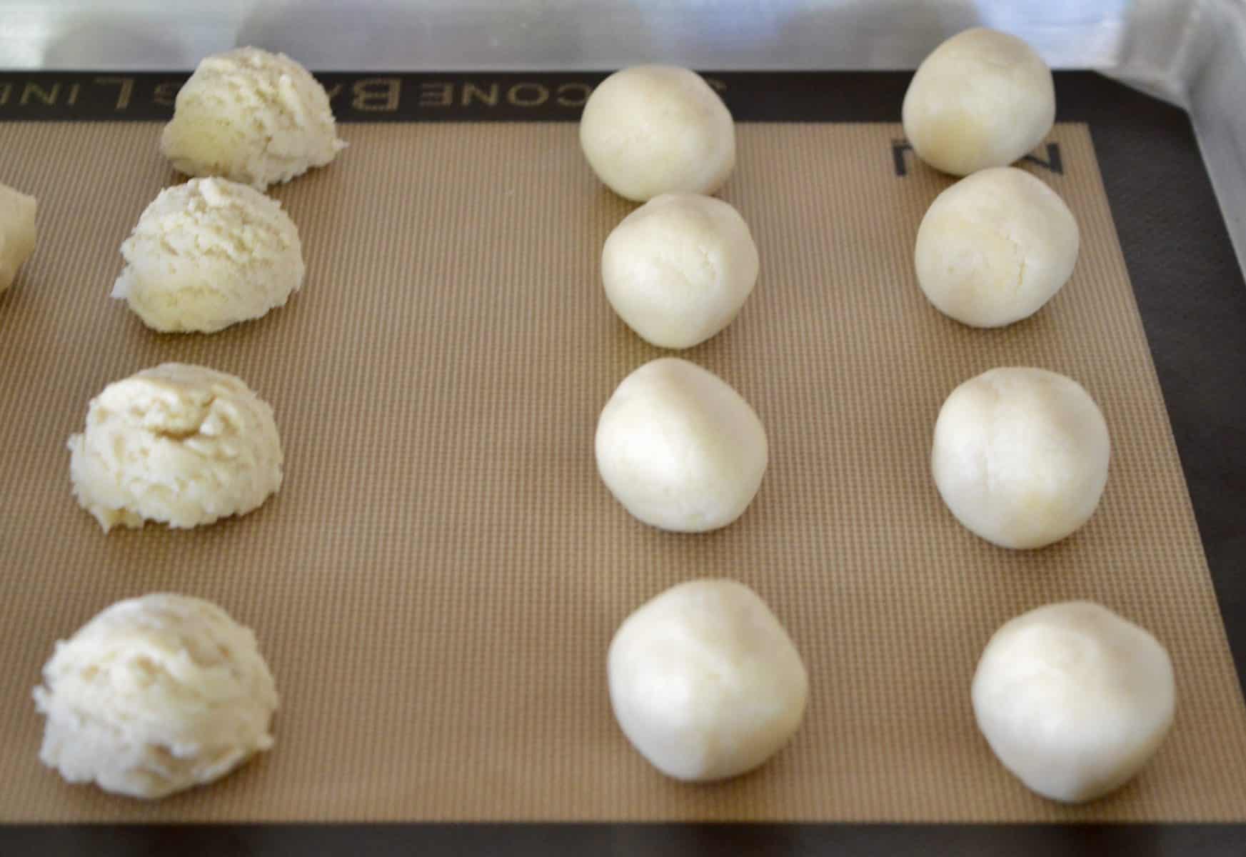 rolling dough into balls on baking mat.