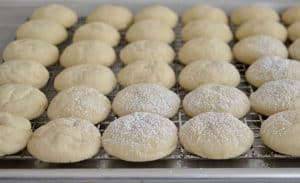 Greek Butter cookies getting dusted with powdered sugar.