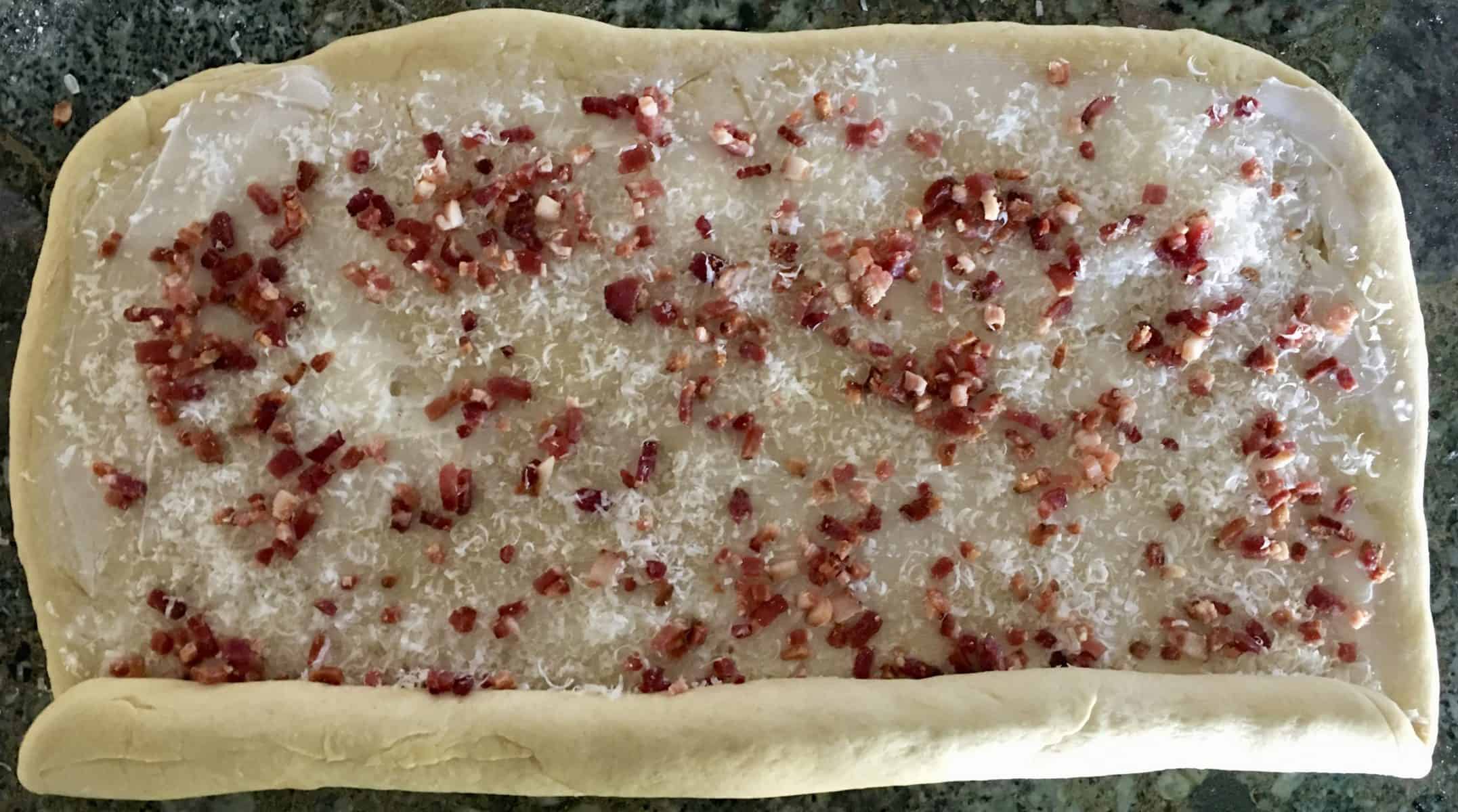 rolling the bread dough into a log form. 