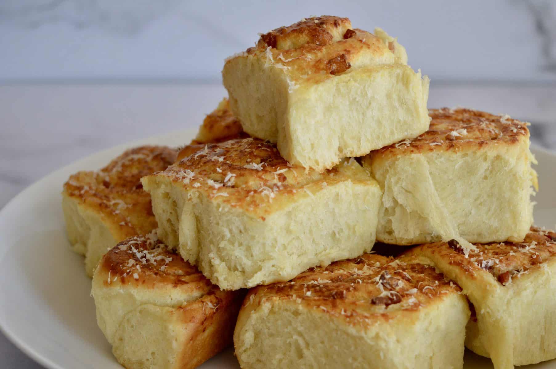 Pinwheel Bread Rolls stacked on a white plate.