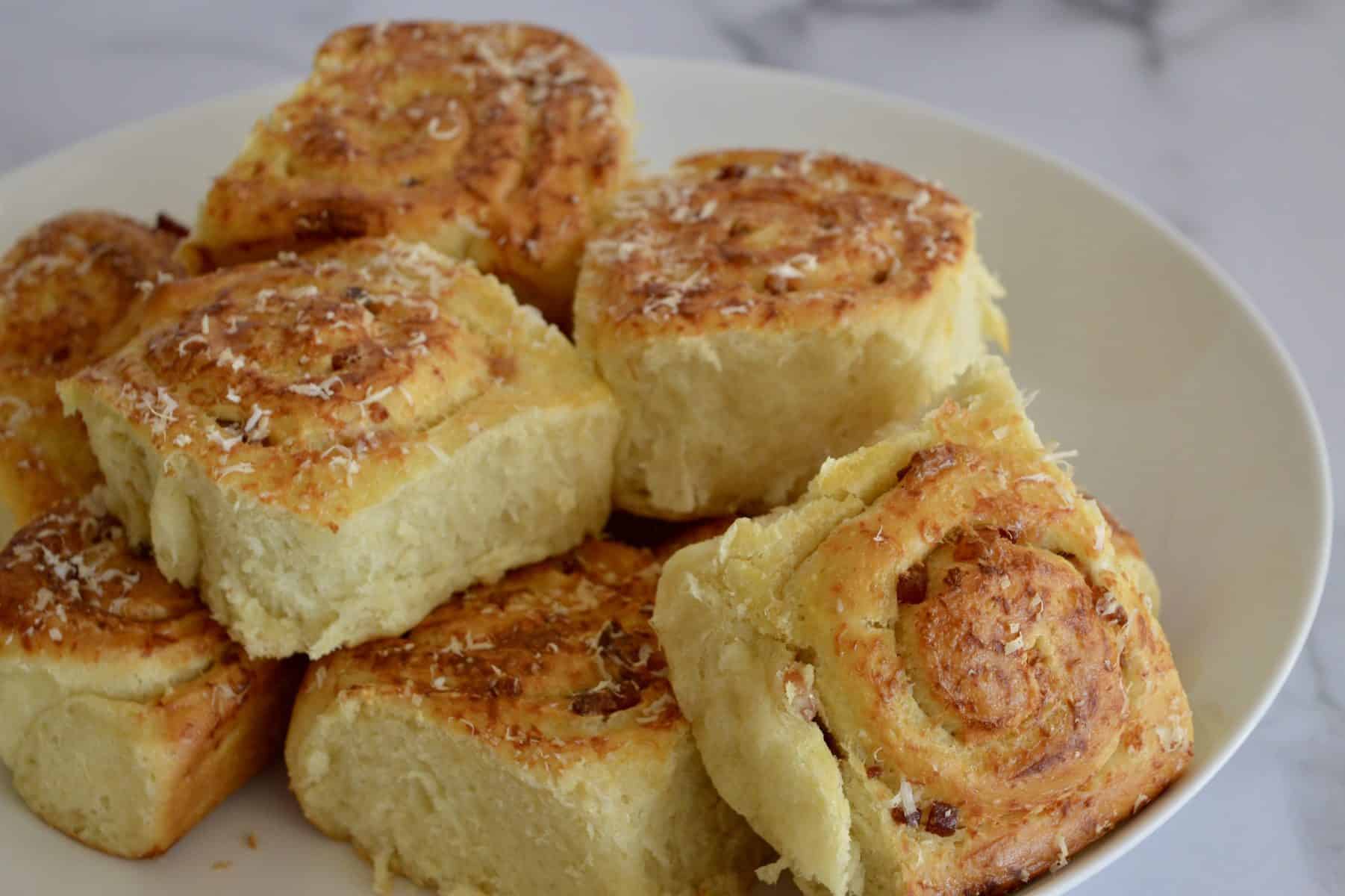 pinwheel bread rolls on a white serving platter. 