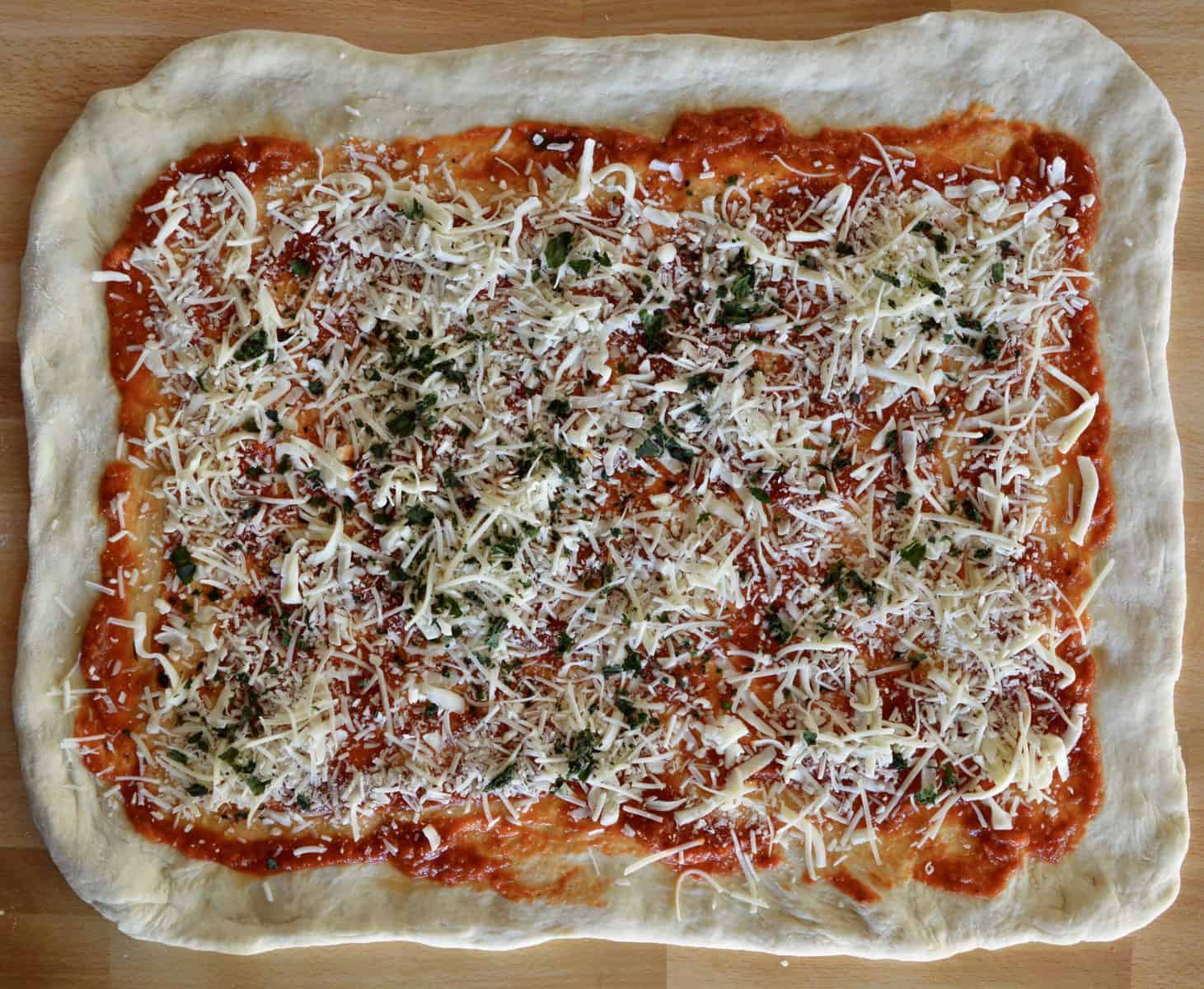 mozzarella and parmesan sprinkled over the Stromboli dough. 