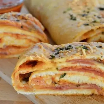 Italian Stromboli on a wood cutting board.