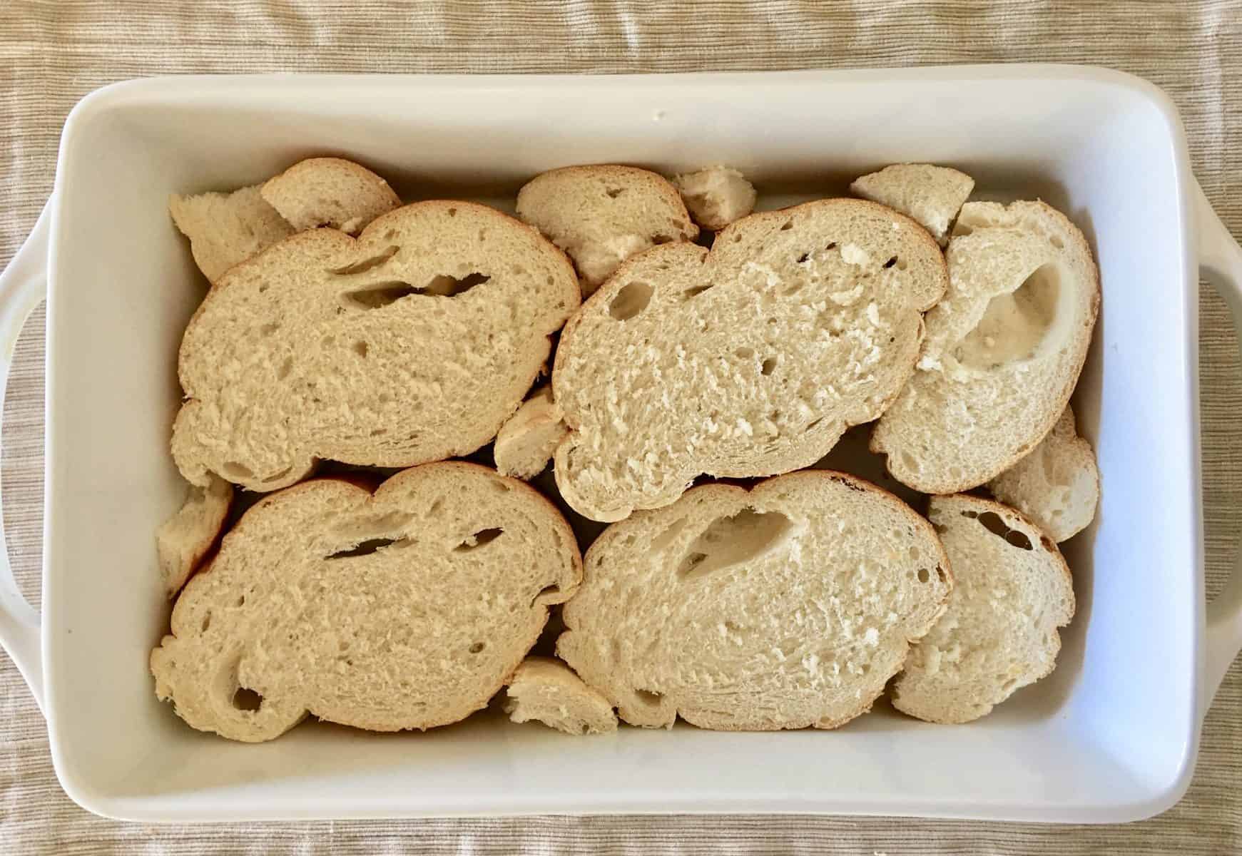 bread in the bottom of a casserole dish. 