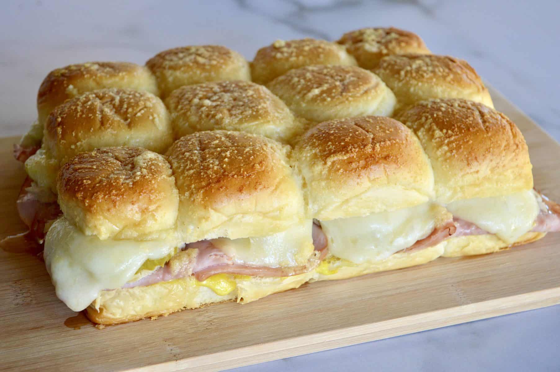 Cuban Sliders on a wood cutting board.