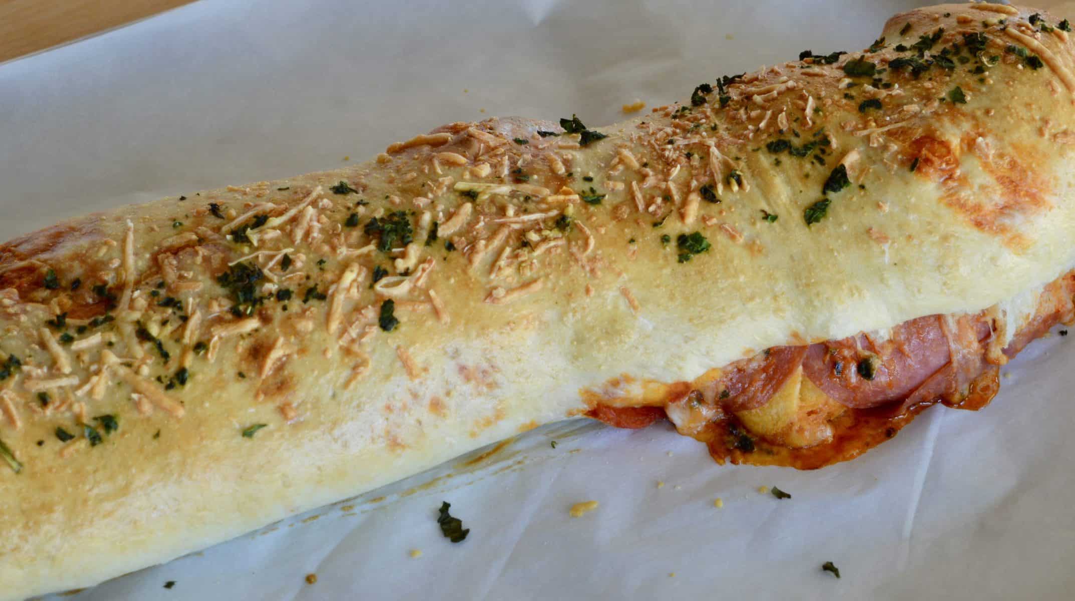 Italian Stromboli recipe baked and on parchment paper. 