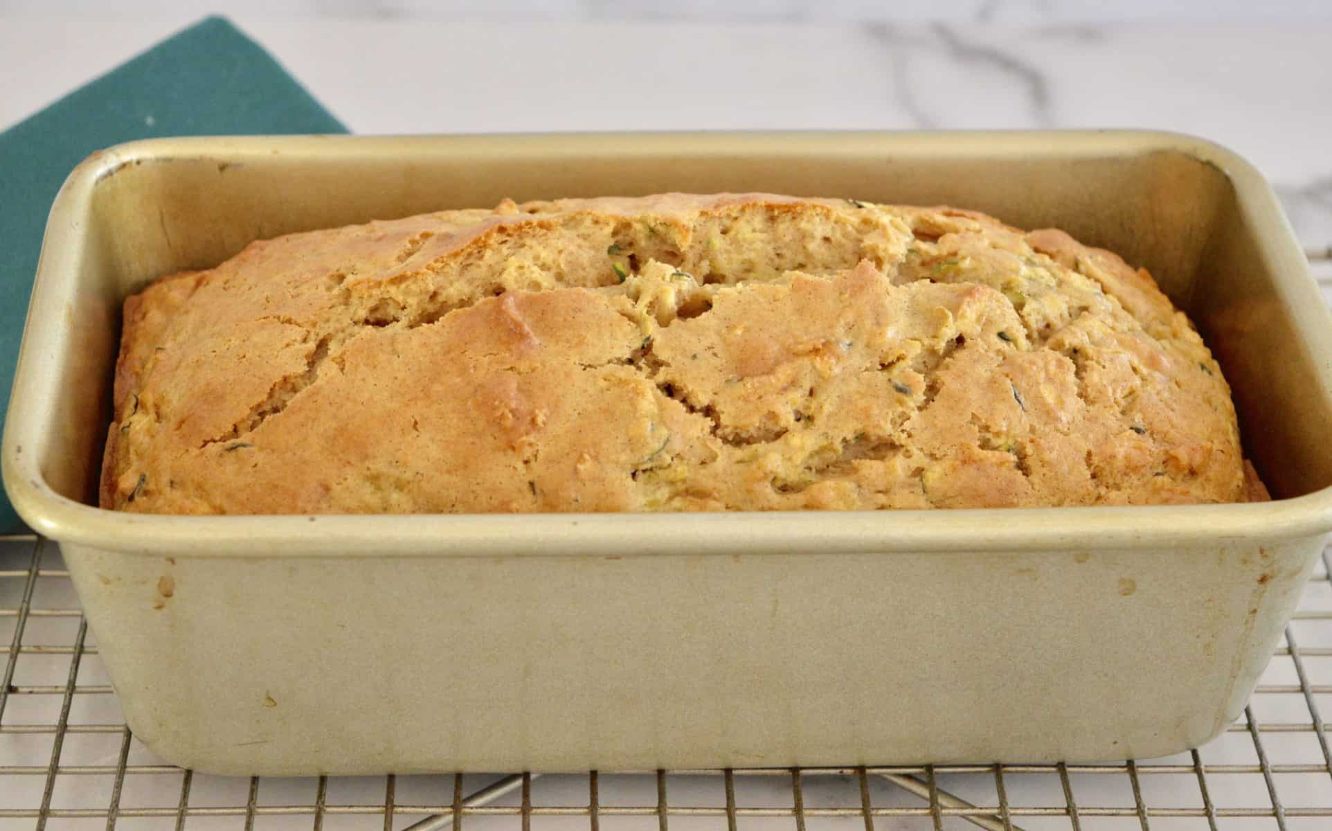 quick loaf in a metal baking pan on a cooling rack. 