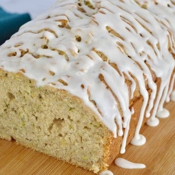 Glazed Zucchini Apple Bread on a wood cutting board.